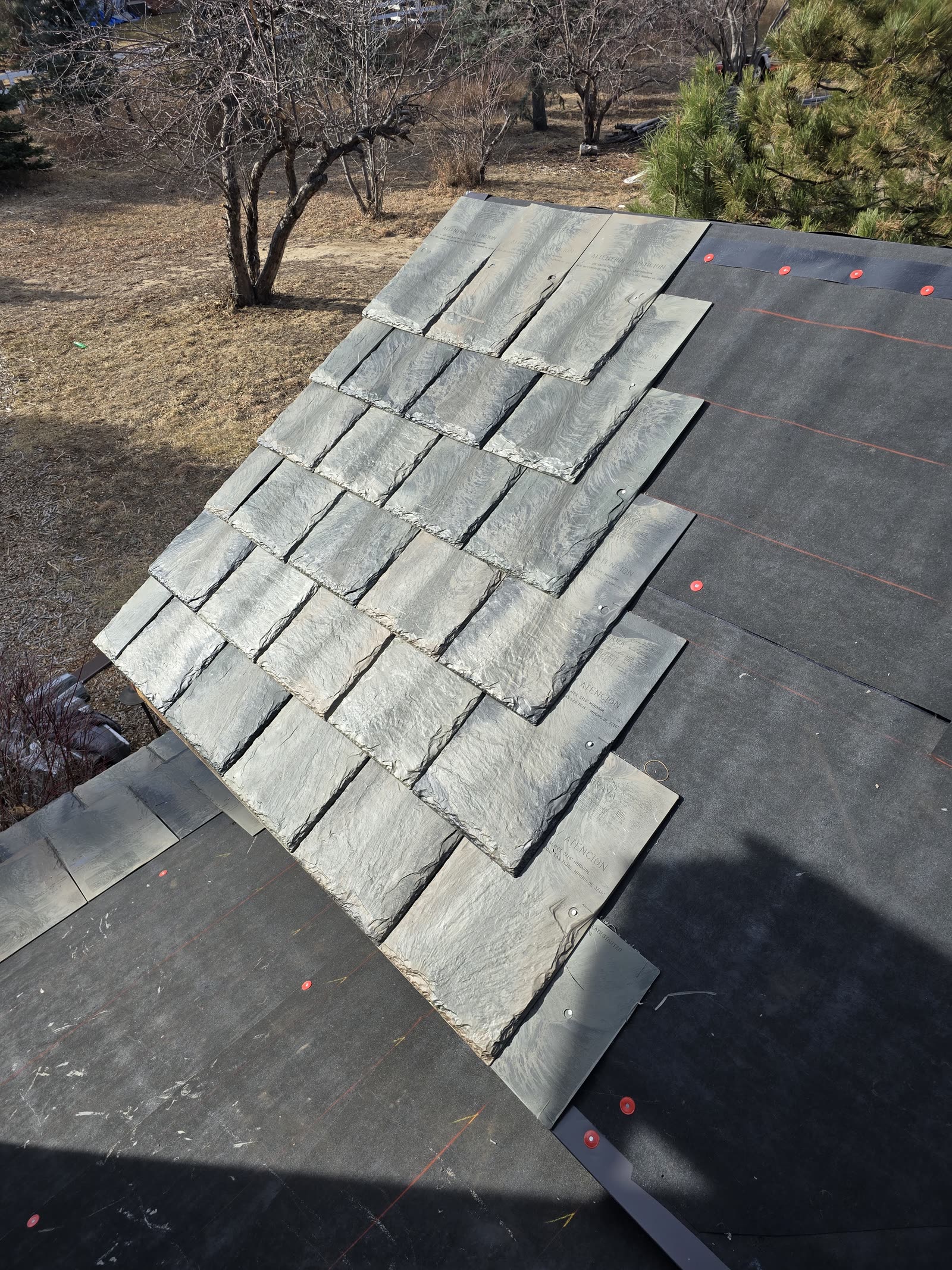 Composite synthetic slate shingles staged for installation on a Front Range custom home