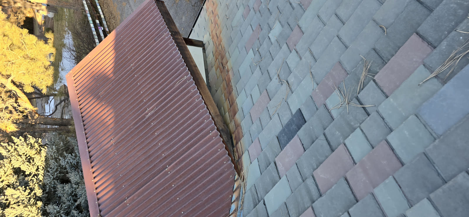 Original multi-color slate roof with weathered Corten panel before tear-off